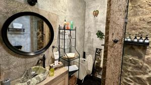 a bathroom with a mirror and a sink and a toilet at Loft Giofiel in Santeagueda