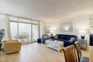 a living room with a blue couch and a table at Pyramid 8K in Ocean City