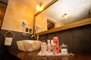 a bathroom with a sink with soap and a mirror at Departamento Olivos 4 in Santeagueda