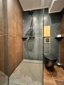 a shower with a glass door in a bathroom at Appartement moderne style chalet in Le Monêtier-les-Bains +5 photos