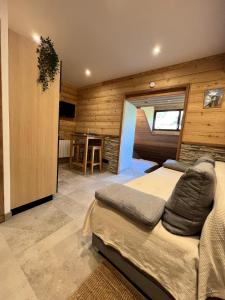 a bedroom with a bed in a room with wooden walls at Appartement moderne style chalet in Le Monêtier-les-Bains
