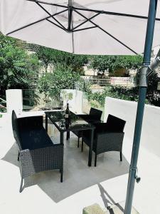 a table and chairs with an umbrella on a patio at JOHNMAR apartment in Athens +10 photos