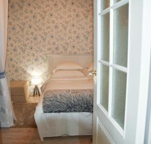 a bedroom with a bed with a blanket on it at Paju Apartment in Võru