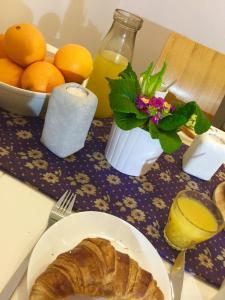 a table with a plate of bread and a bowl of oranges at Suur-Ameerika Apartment in Tallinn