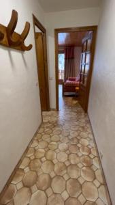 a hallway with a room with a floor with at Studio Croix Viallet, Chez Francine in Notre-Dame-de-Bellecombe