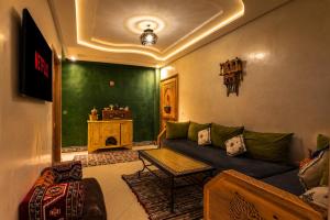 a living room with a couch and a table at Al manar in Oulad Akkou