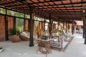 a screened in porch with a table and chairs at Hotel Santa Amalia in Vassouras +64 photos