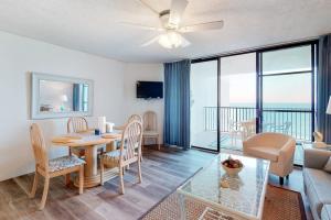 a living room with a table and chairs and a living room at Pyramid 9G in Ocean City