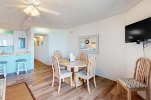 a dining room with a table and chairs and a kitchen at Pyramid 9G in Ocean City