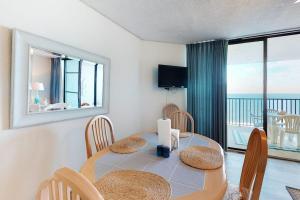 a dining room with a table and chairs with a view of the ocean at Pyramid 9G in Ocean City +13 photos