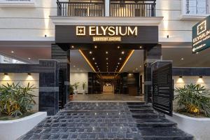 a lobby of a hotel with a sign that reads elysium at ELYSIUM Premier Suites Hitec City in Hyderabad