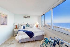 a bedroom with a bed with a view of the ocean at Antigua 1004 in Ocean City