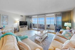 a living room with a couch and a table at Antigua 1004 in Ocean City