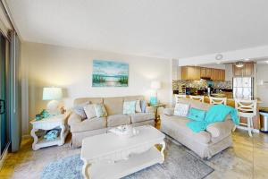 a living room with a couch and a table at Antigua 1004 in Ocean City