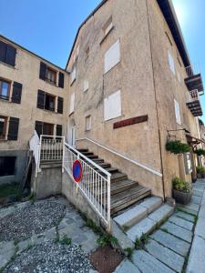 a brick building with stairs next to a building at Appartement moderne style chalet in Le Monêtier-les-Bains