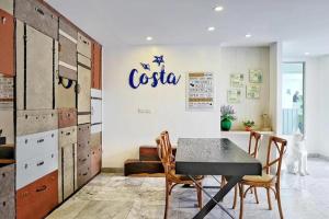 a dining room with a table and wooden cabinets at Costa Village Jacuzzi Bangsaray in Bang Sare +92 photos