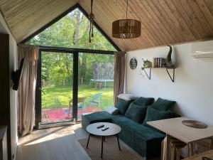 a living room with a green couch and a table at RiverHouse in Bałtów