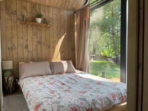 a bedroom with a bed and a large window at RiverHouse in Bałtów +23 photos