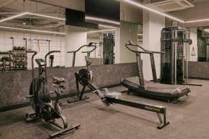 a gym with three exercise bikes in a room at Ember Locke Kensington in London