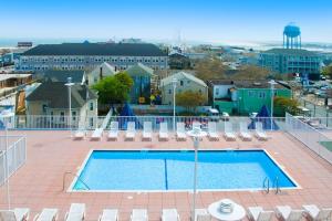 a large swimming pool with chairs and a city at Belmont Towers 407 in Ocean City