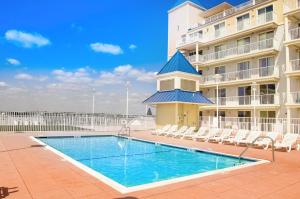 a swimming pool in front of a building at Belmont Towers 407 in Ocean City