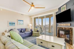 a living room with a couch and a fireplace at Belmont Towers 407 in Ocean City