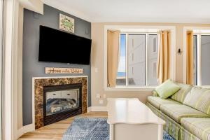 a living room with a couch and a fireplace at Belmont Towers 407 in Ocean City +33 photos