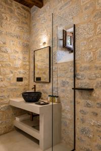 a bathroom with a sink and a mirror at Petra & Fos Boutique Hotel & Spa in Neo Itilo +123 photos