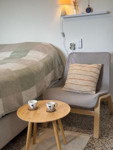 a bedroom with a bed and a table with cups on it at Admonis - Home in the olive grove in Melissátika +51 photos