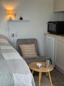 a bedroom with a bed and a coffee table at Admonis - Home in the olive grove in Melissátika