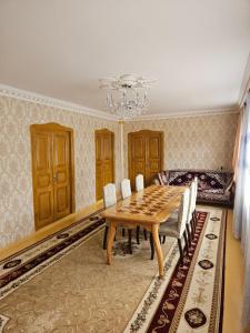 a dining room with a wooden table and chairs at Qecresh Garden House in Qǝçrǝş