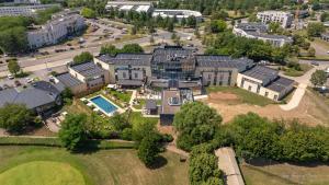 an aerial view of a large house with a yard at Best Western Plus Metz Technopole in Metz
