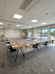 a classroom with tables and chairs in a room at Best Western Plus Metz Technopole in Metz +63 photos