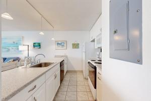 a white kitchen with a sink and a refrigerator at Pyramid 6G in Ocean City