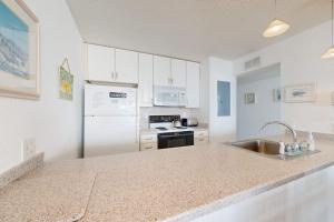 a white kitchen with a sink and a refrigerator at Pyramid 6G in Ocean City