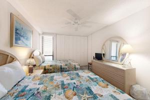 a bedroom with a bed and a dresser and a mirror at Pyramid 6G in Ocean City +8 photos