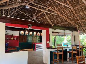 a kitchen with a table and chairs in a room at One Love Garden Villas Paje in Kiganga