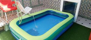a swimming pool with a swing in a house at Appartement terrasse climatisée in Tunis