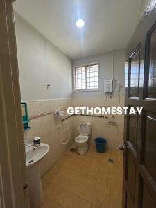 a bathroom with a toilet and a sink at Gethomestay Keningau in Keningau