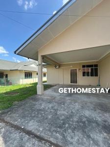 a building with a sign on the side of it at Gethomestay Keningau in Keningau
