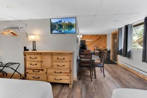 a bedroom with a desk and a table with chairs at Timber Ridge Lodge Ouray in Ouray