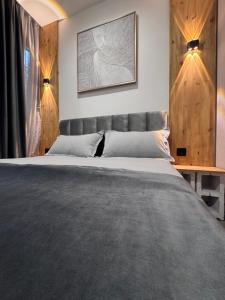 a bedroom with a large bed with a headboard at Dream House in Yerevan