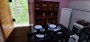 a kitchen with a table and chairs and a table and a refrigerator at CasaLima in Bragança