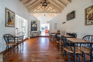 a dining room with wooden tables and chairs at Casa Campo Hotel Boutique - San Pedro in San Pedro