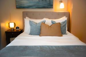 a bed with blue and white pillows on it at Paladium Iloilo Smart Home Condo in Iloilo City +37 photos
