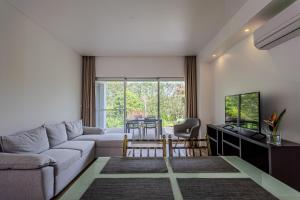 a living room with a couch and a table at Quinta De Santana in Rabo de Peixe