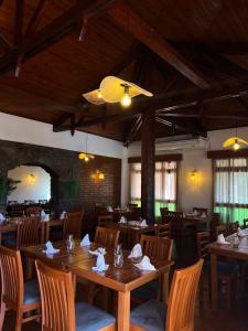 a dining room with wooden tables and chairs at Hotel & Restaurant Las Brisas in Puerto Esperanza