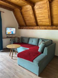 a living room with a couch and a table at Vikendica Vesic Tegare in Bratunac