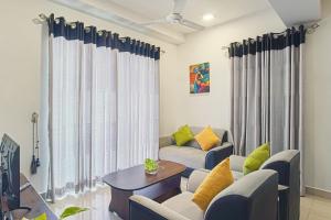 a living room with a couch and a table at Lovish luxury villa in Colombo