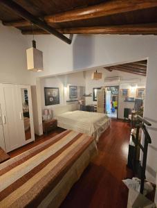 a large bedroom with a bed and a living room at Casa da Minha Avó in São Pedro de Solis